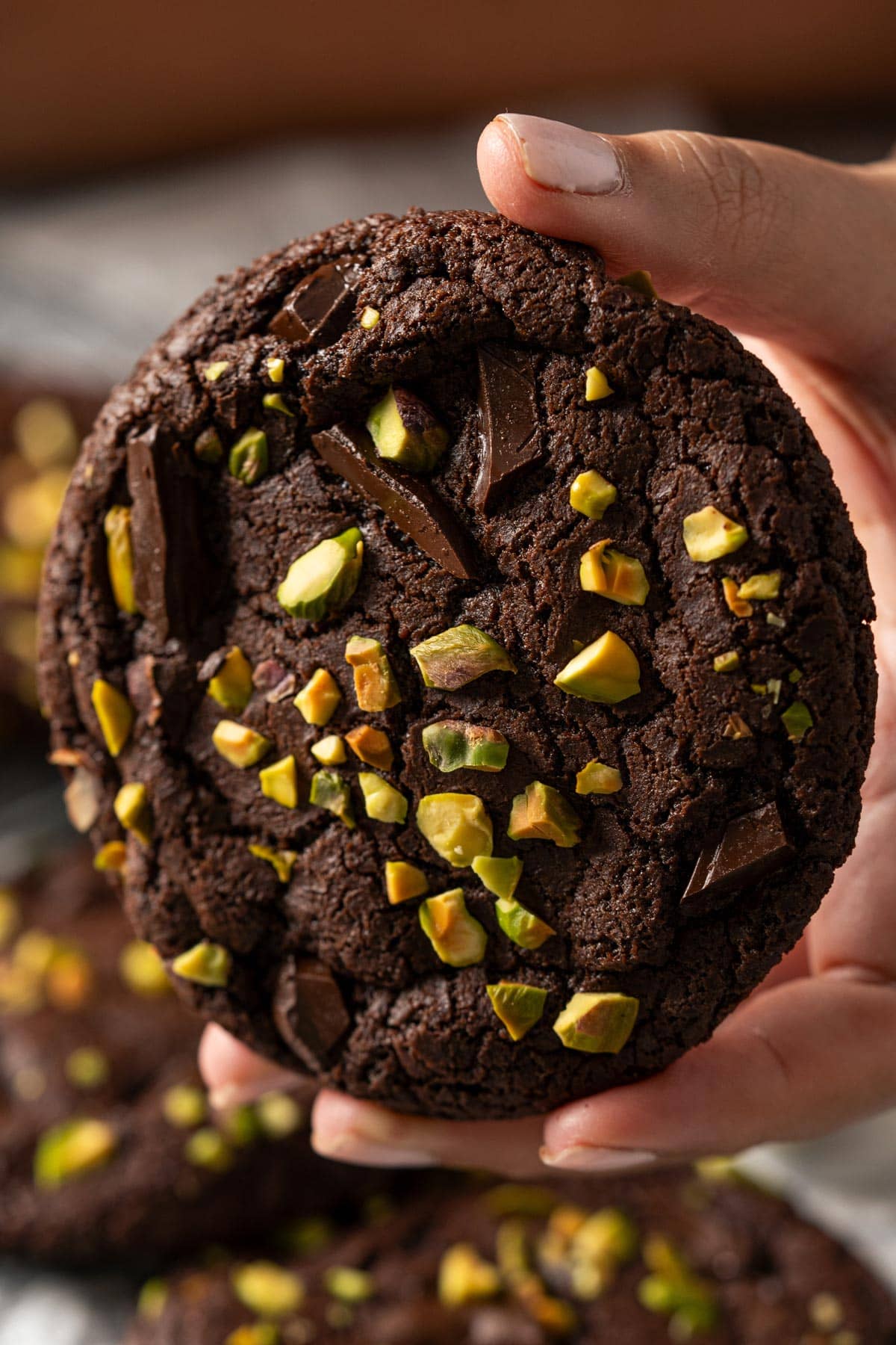 Holding a chocolate cookie.