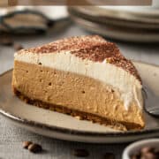 A slice of coffee cheesecake on a plate.