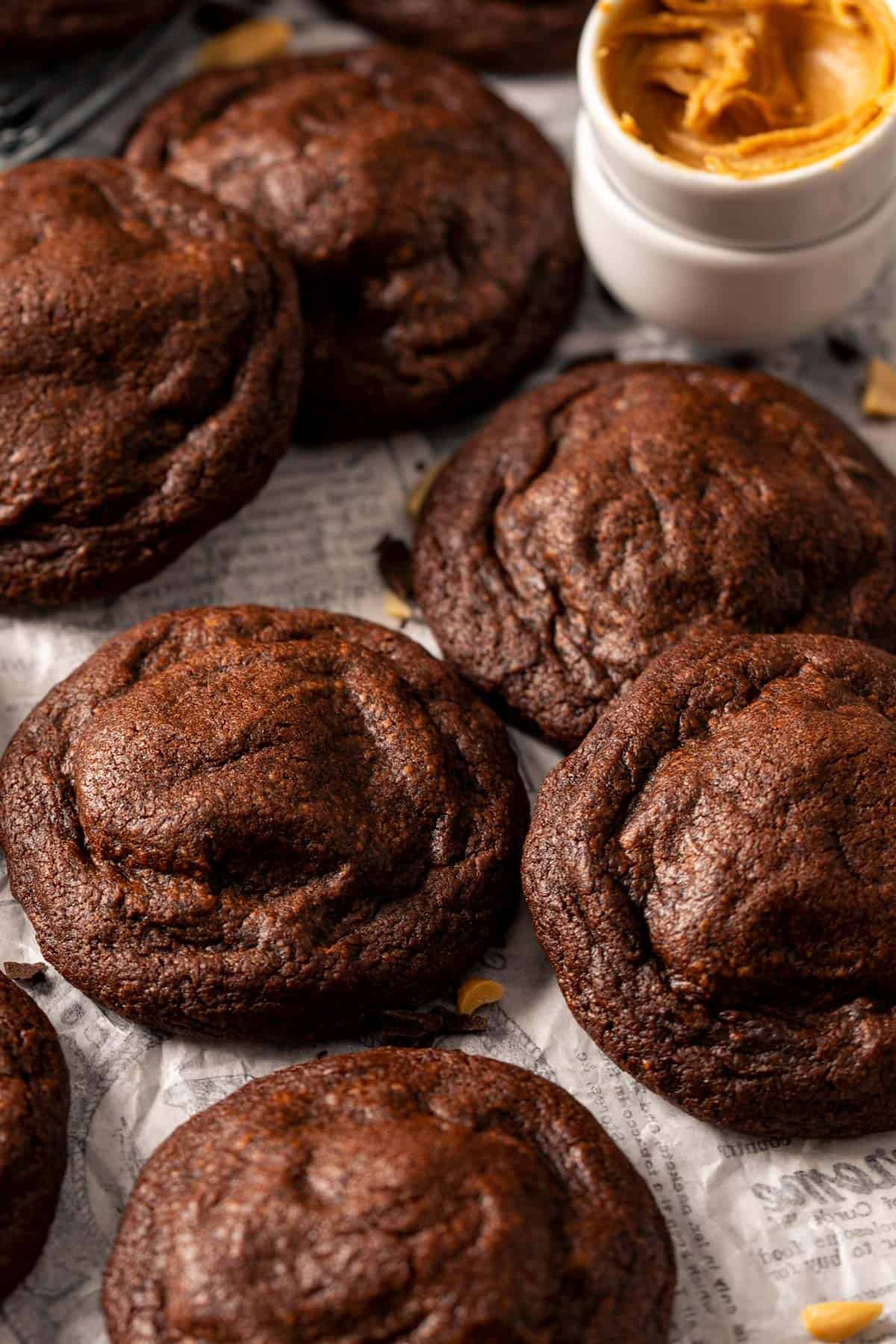 Peanut butter stuffed chocolate cookies on a parchment paper.