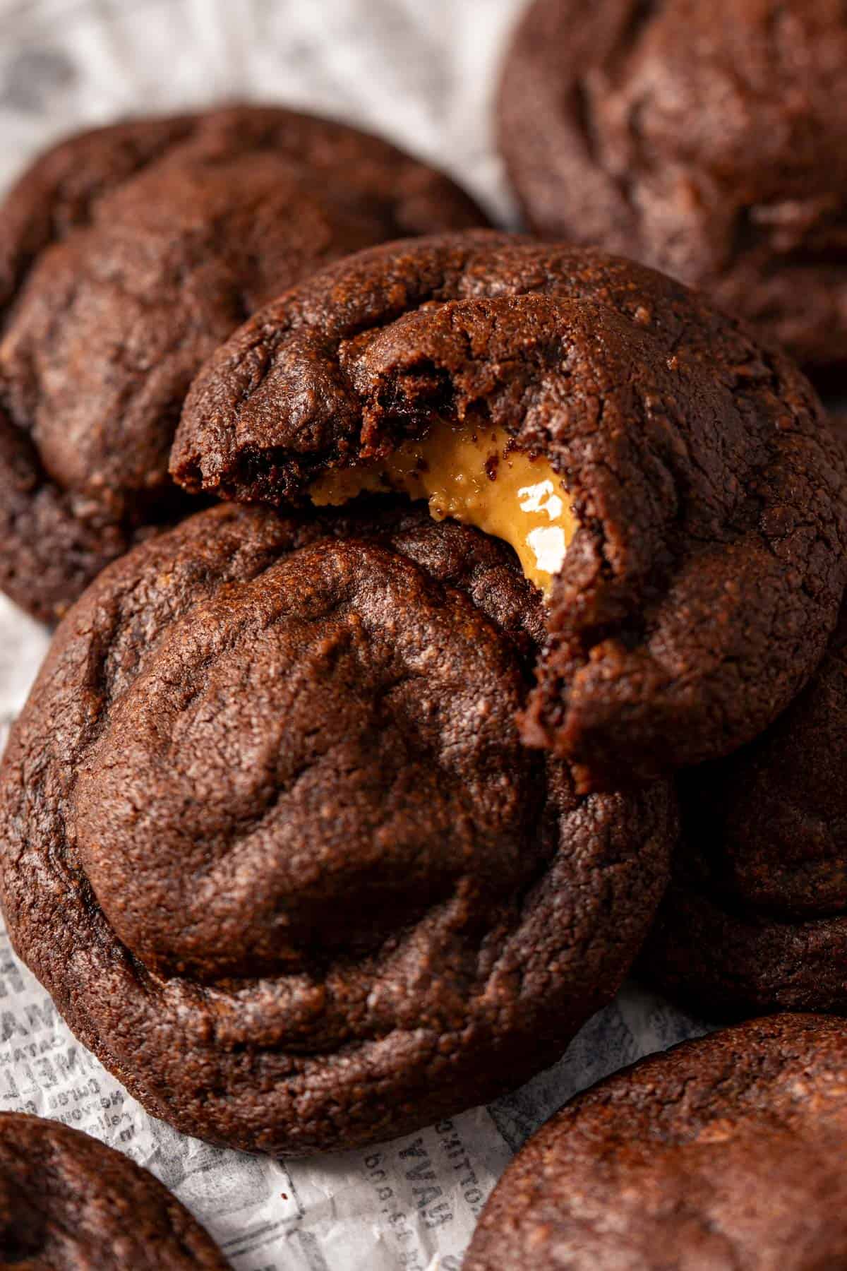 Peanut butter stuffed chocolate cookies showing gooey filling.