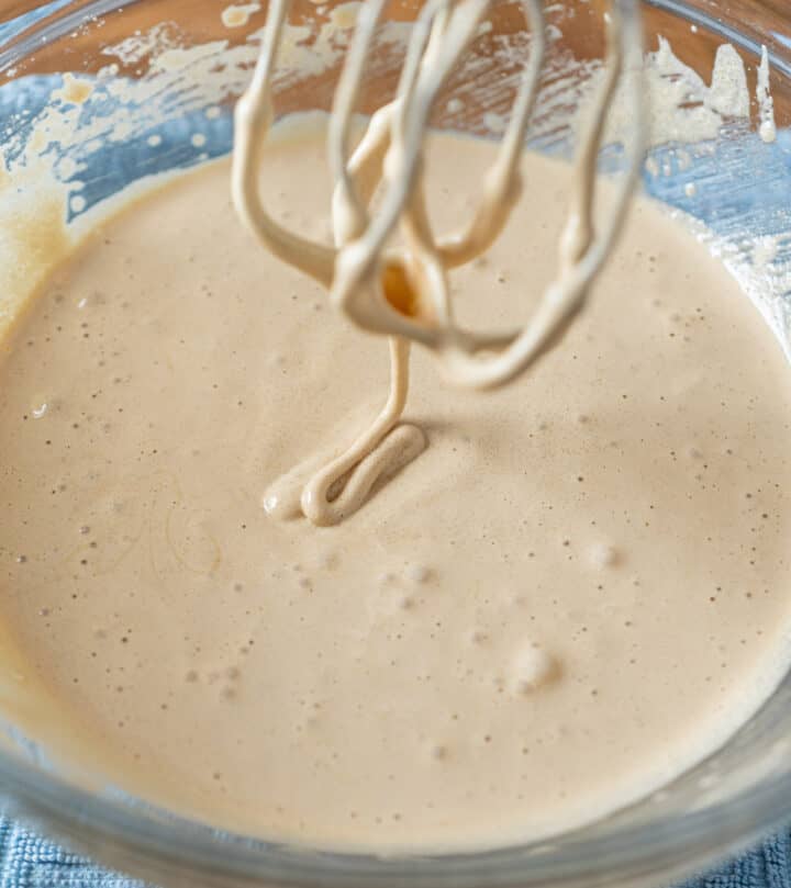 Whisking eggs and sugar until pale and thick for fudgy brownie-style cookie base.