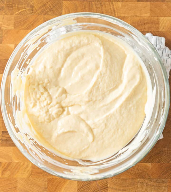 Folding beaten eggs into the batter.