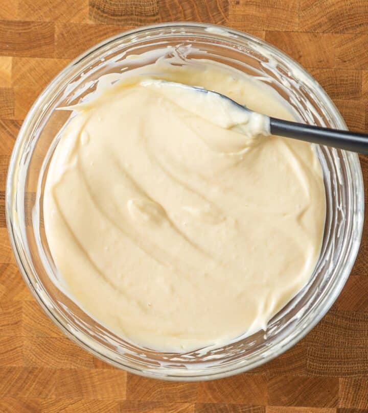 Folding eggs into the cream cheese batter.