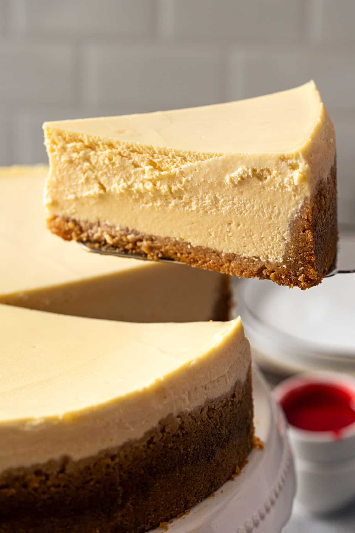 Holding a slice of New York Cheesecake.