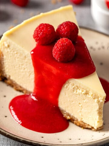 New York Cheesecake with no water bath topped with raspberry coulis.