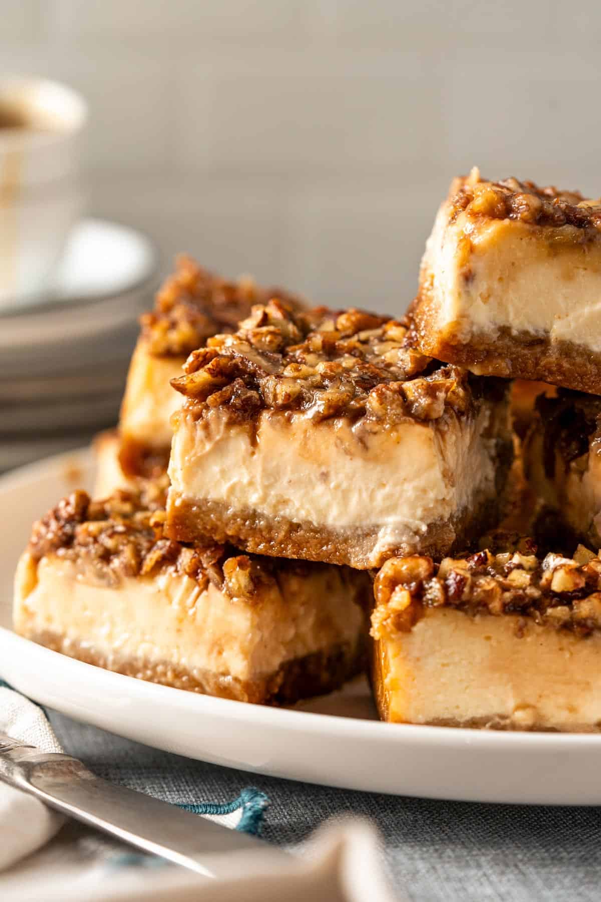 Pecan pie bars stacked on a plate.