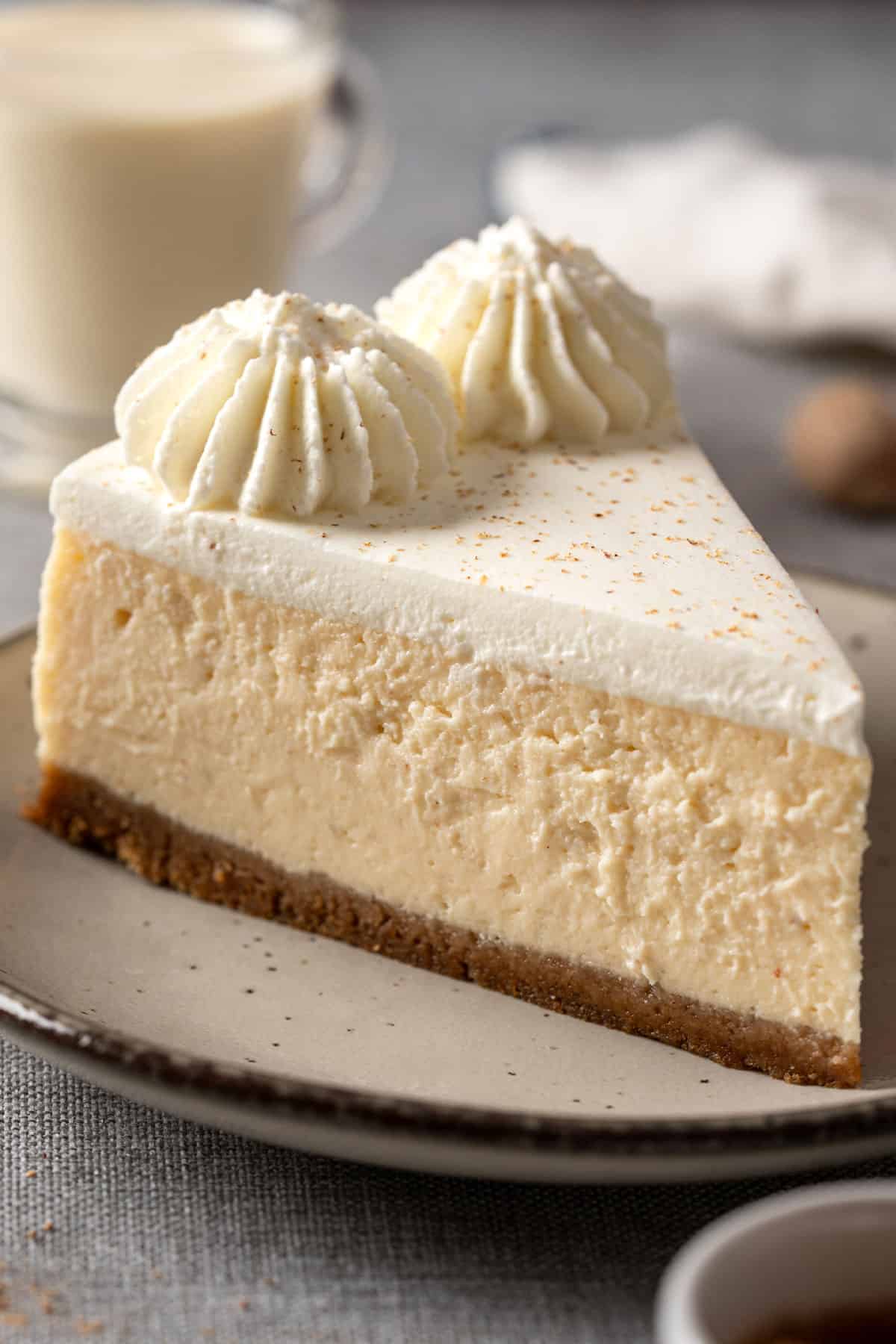 A slice of eggnog cheesecake baked with no water bath.