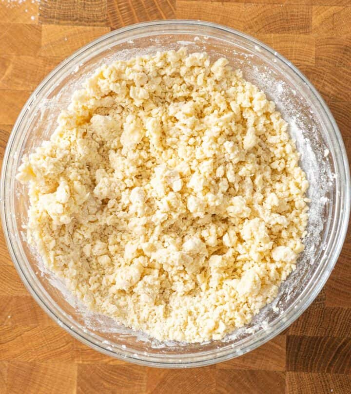 Mixing dry ingredients and getting a crumbly dough.