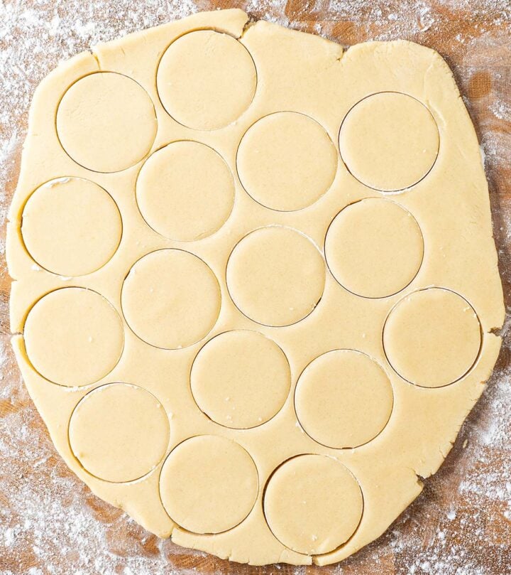 Rolling the dough and cutting it into circles.
