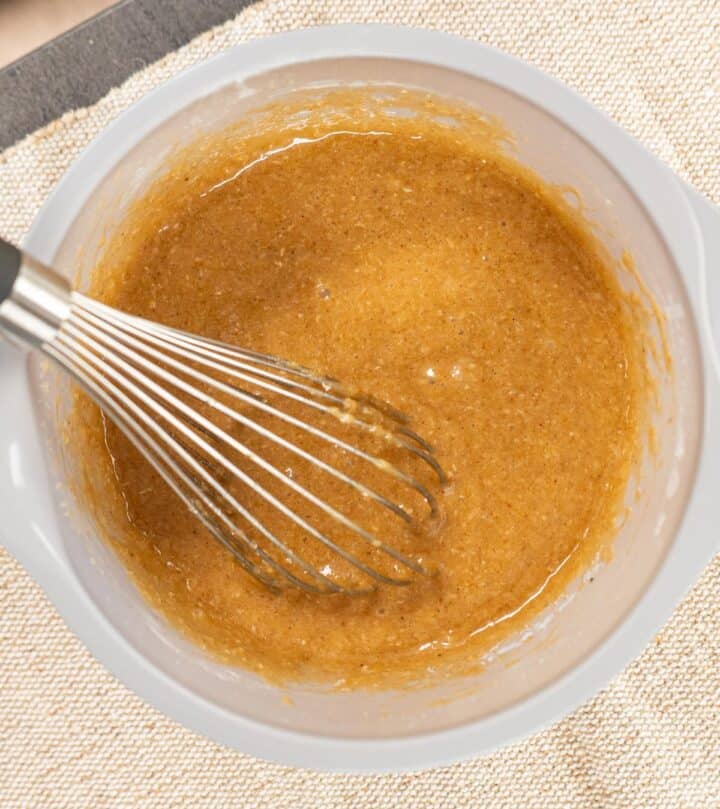 Mixing flour and spices into carrot cake batter.