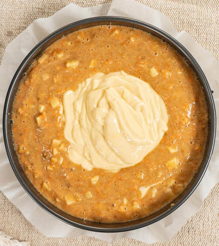 Fourth layer, adding final cheesecake layer before baking.