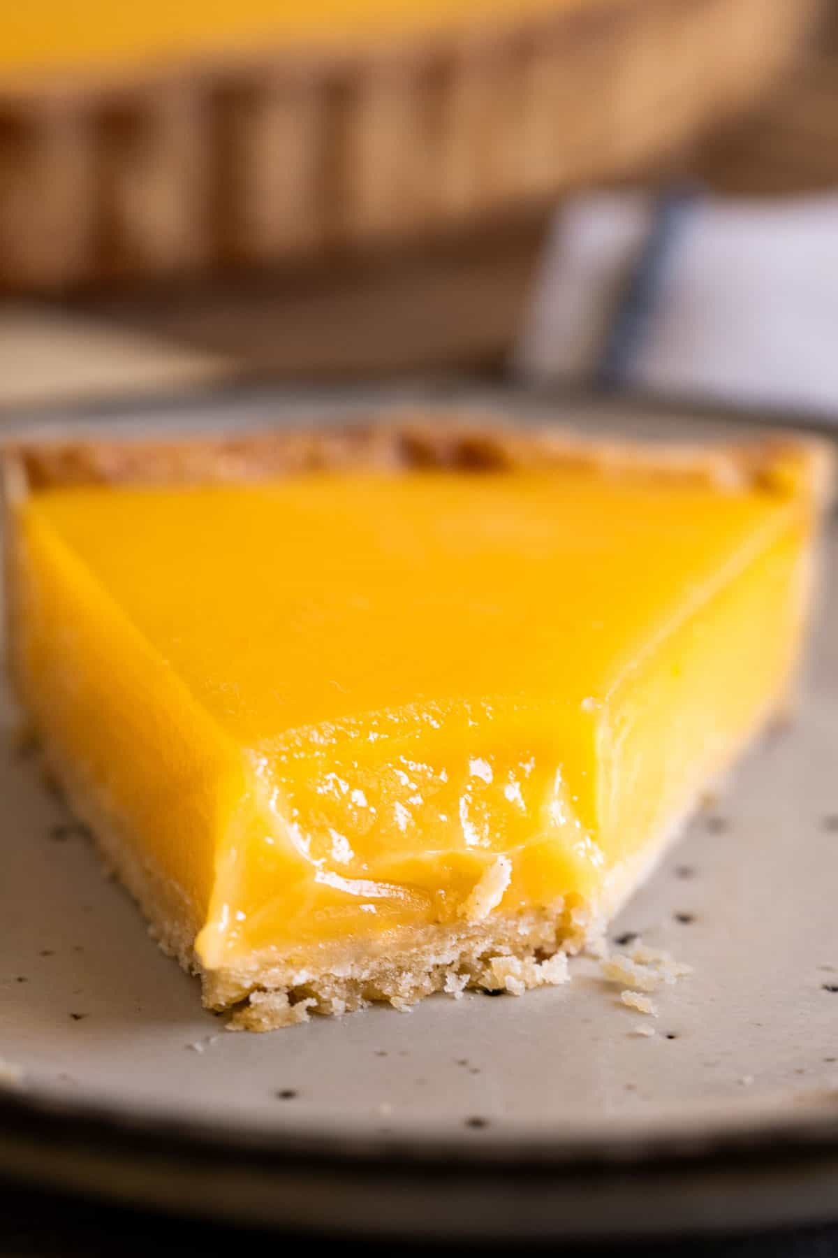 Showing the silky smooth texture of half eaten lemon tart.