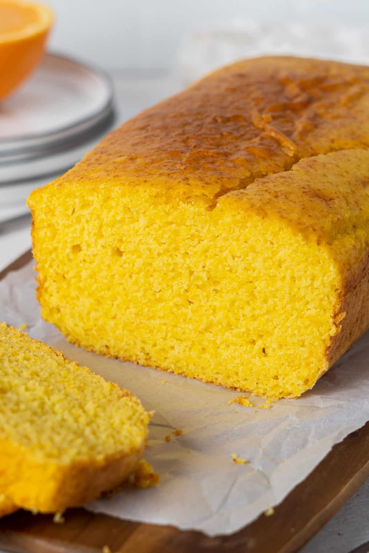 Whole orange cake on a serving plate.