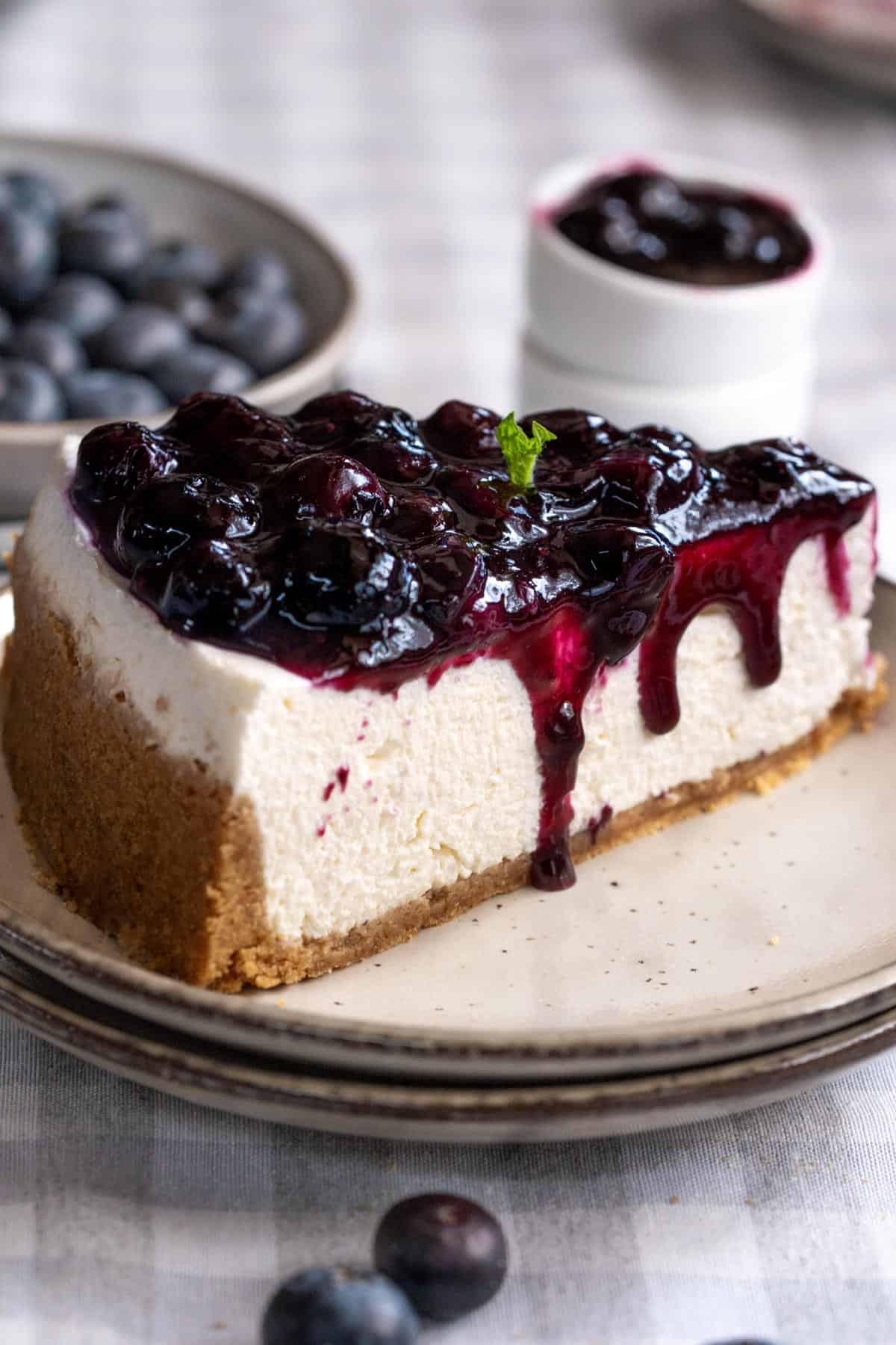 A slice of no-bake blueberry cheesecake on a plate.