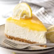 A slice of no bake lemon cheesecake on a plate.