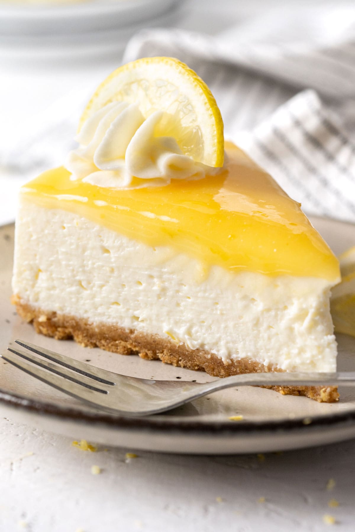A slice of no-bake lemon cheesecake on a plate.