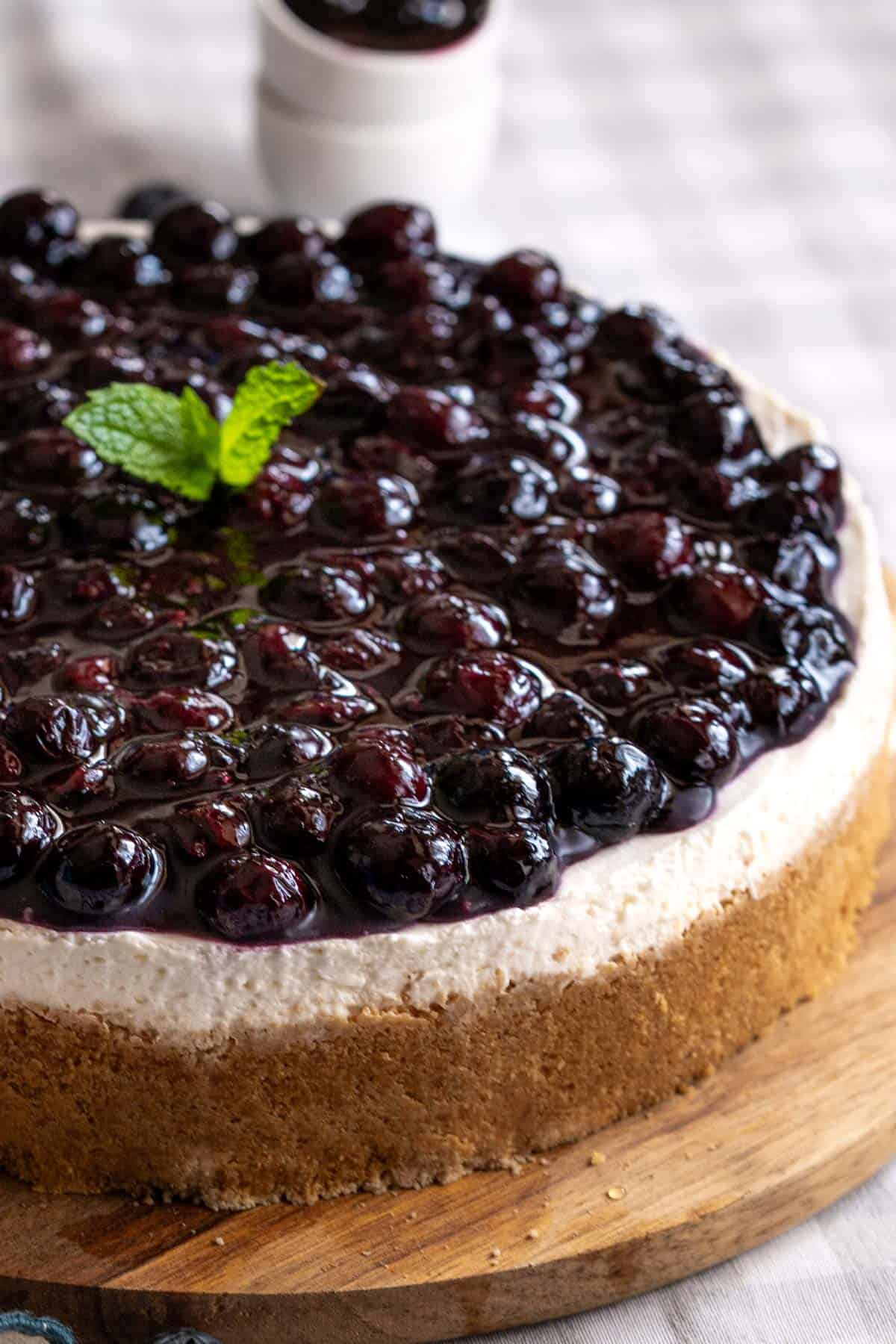 A whole no-bake blueberry cheesecake on a serving plate.