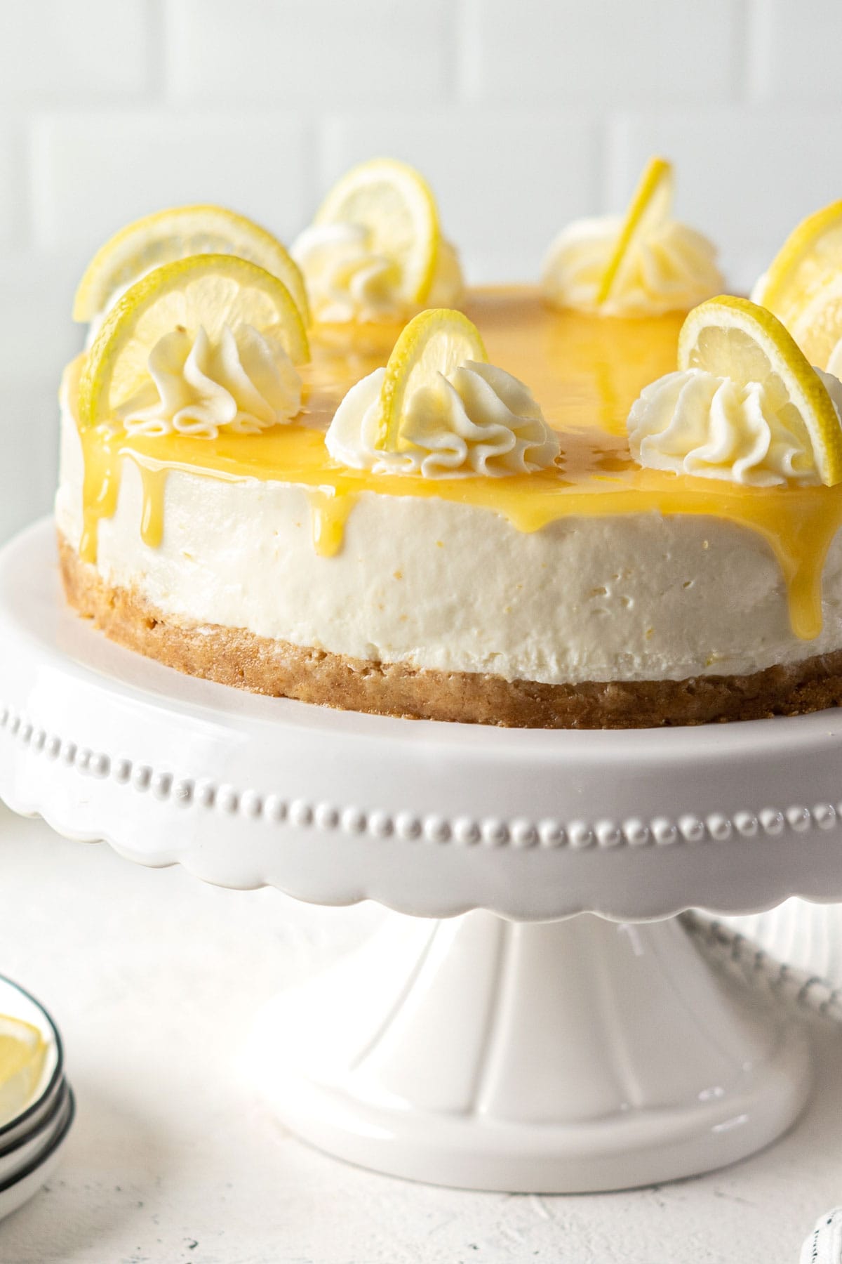No-bake lemon cheesecake on a cake stand.