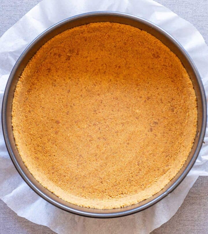 Pressing the crumbs into the pan.