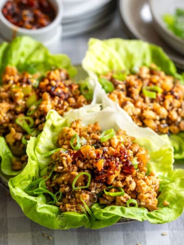 Asian chicken lettuce wraps on a plate.