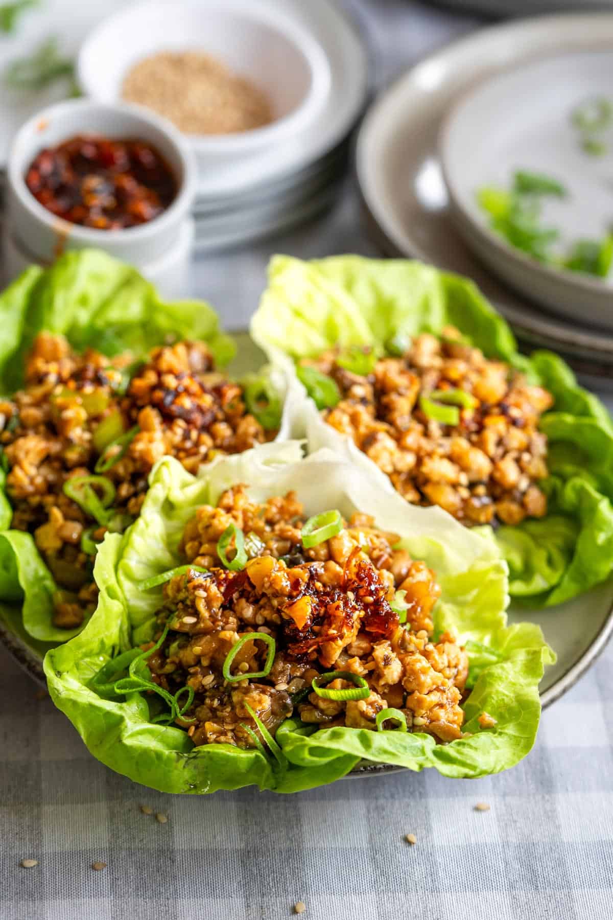 Asian chicken lettuce wraps on a serving plate.