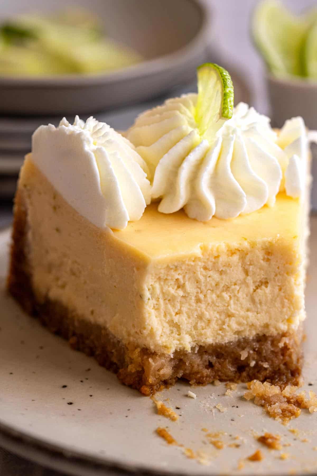 Half eaten slice of cheesecake.