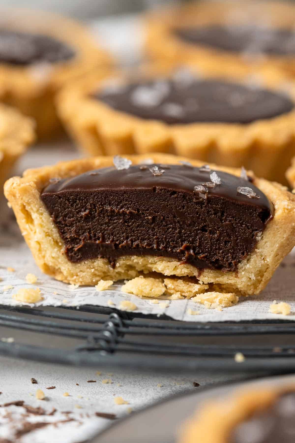 Half of mini chocolate tart showing the creamy filling.
