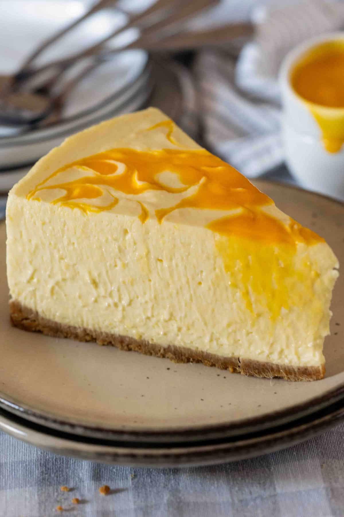 A slice of mango cheesecake on a plate.