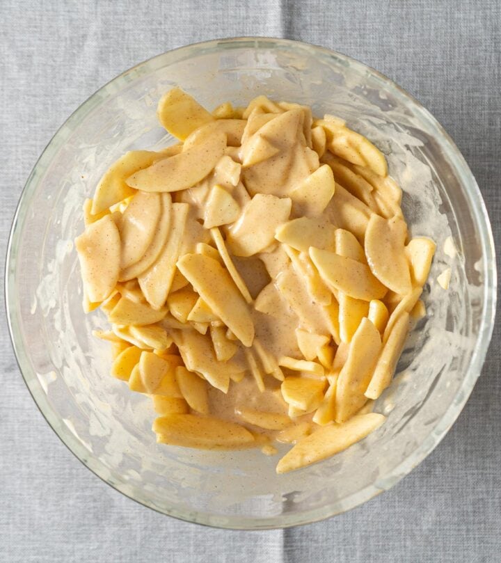 Coating the apples slices with the batter.