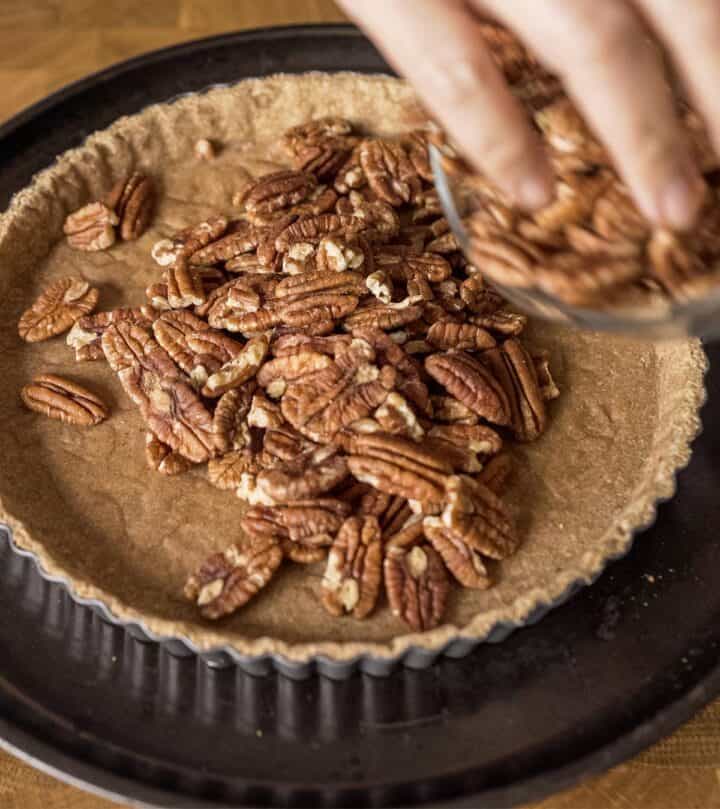 Adding the pecans to the crust.
