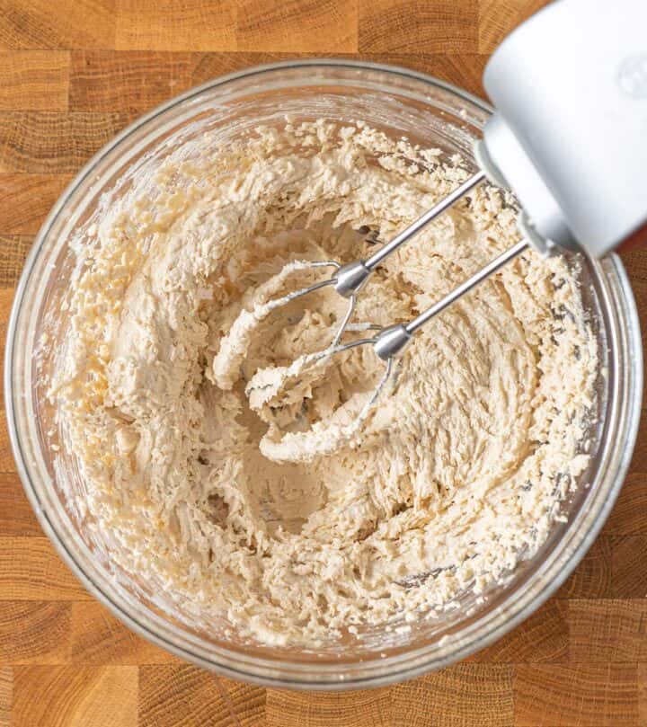 Beating butter with sugars.